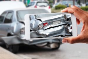 close-up-hand-holding-smartphone-and-take-photo-of-car-accident
