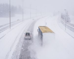 truck and van driving in snow