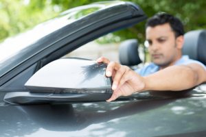 man fixing backview mirror