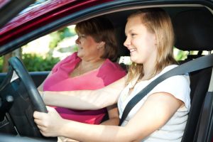 Teenage girl driving with seatbelt on