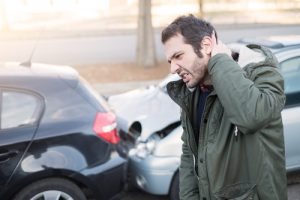 man holding his neck after a car wreck