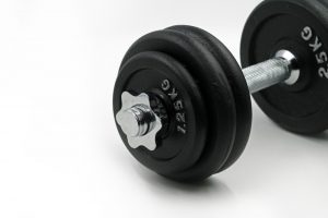 free weights dumbbell against a white background