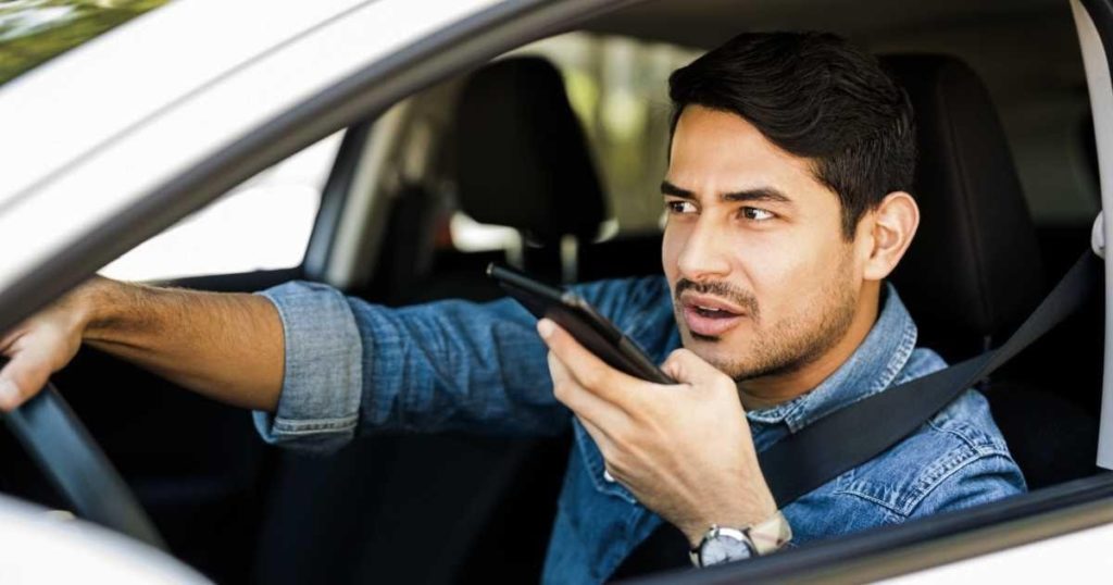 man-using-cell-phone-in-car