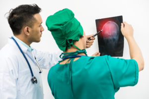 doctors examining a brain scan