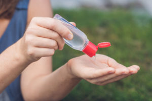 woman using hand sanitizer