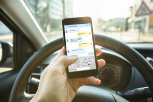 person texting while driving