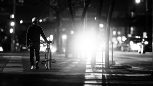 man walking bicycle