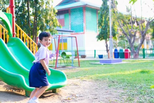 A child plays on the playground at a daycare.