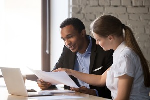 Woman explaining car accident insurance to man