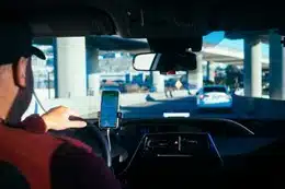 A man uses his phone while driving.
