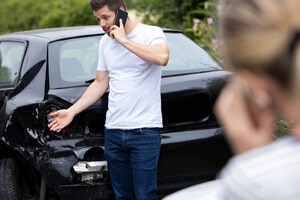 man talking to his insurance company after a car accident