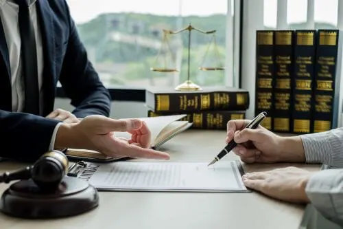 A personal injury lawyer consults with his client about medical bills in a Charlotte law office.